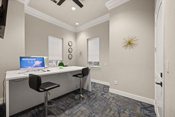 A room with a desk and a computer on it.